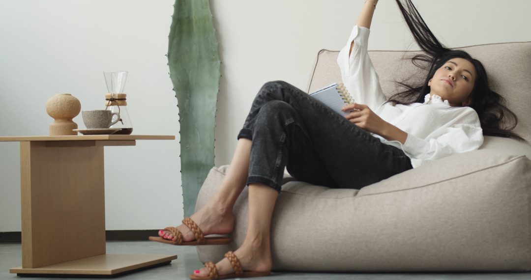 Everyday Japandi Lifestyle - A Woman Resting on a Couch and Playing with Hair 059 Woman Resting on a Couch and Playing with Hair