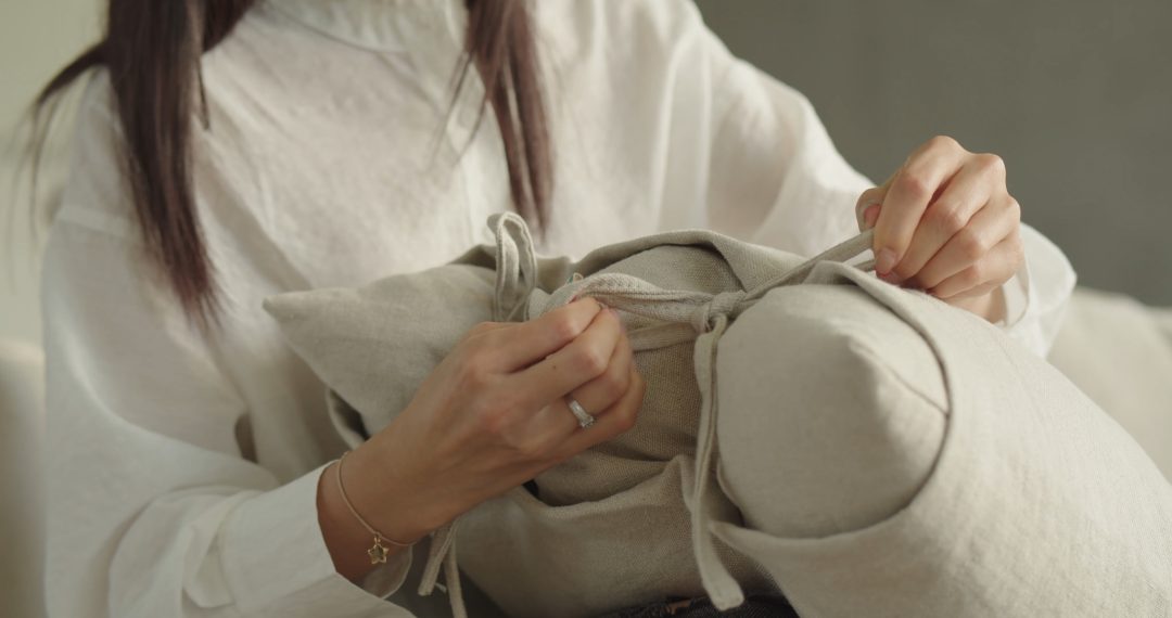 Everyday Japandi Lifestyle - Close-up of A Woman with Painted Nails and Jewelry Tying a Knot on The Pillow 051 Close-up of A Woman with Painted Nails and Jewelry Tying a Knot on The Pillow